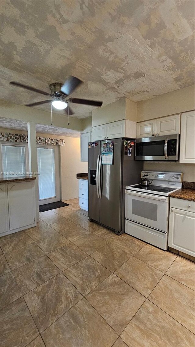3390 SW 15th Ct, Fort Lauderdale, FL 33312 - kitchen with appliances with stainless steel finishes, white cabinetry, dark countertops, a ceiling fan, and a textured ceiling
