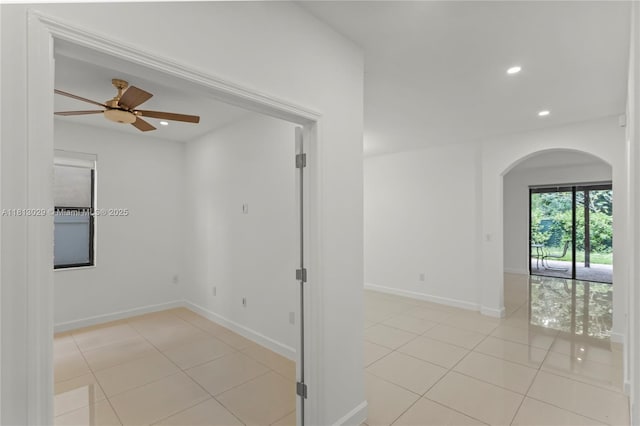 3502 W 86th Ter, Hialeah, FL 33018 - spare room with arched walkways, light tile patterned flooring, recessed lighting, ceiling fan, and baseboards