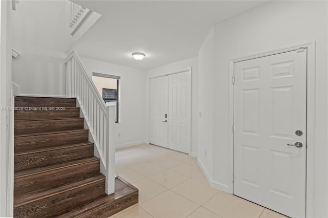 3502 W 86th Ter, Hialeah, FL 33018 - entryway with stairs, light tile patterned floors, and baseboards