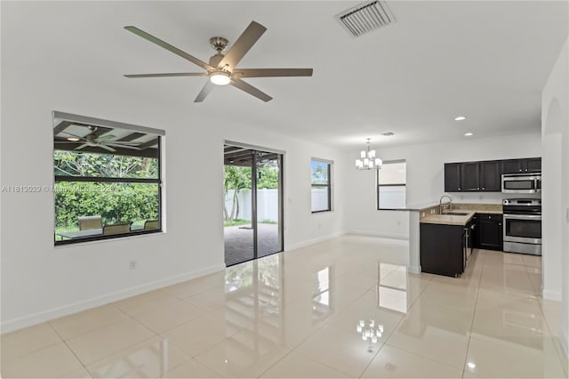 3502 W 86th Ter, Hialeah, FL 33018 - unfurnished living room with a sink, a chandelier, baseboards, light tile patterned floors, and a ceiling fan
