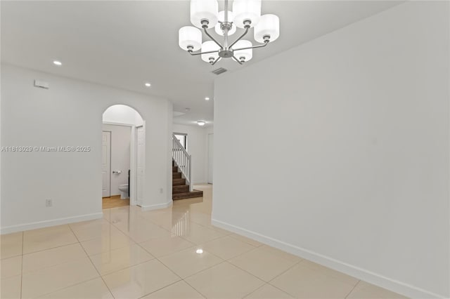 3502 W 86th Ter, Hialeah, FL 33018 - unfurnished room with arched walkways, stairway, a chandelier, baseboards, and recessed lighting