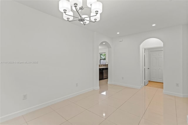 3502 W 86th Ter, Hialeah, FL 33018 - spare room featuring arched walkways, a chandelier, baseboards, recessed lighting, and light tile patterned flooring