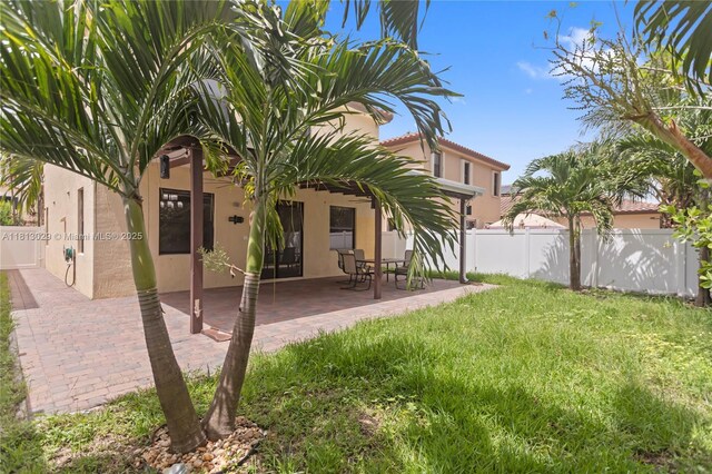 3502 W 86th Ter, Hialeah, FL 33018 - rear view of property featuring stucco siding and a patio