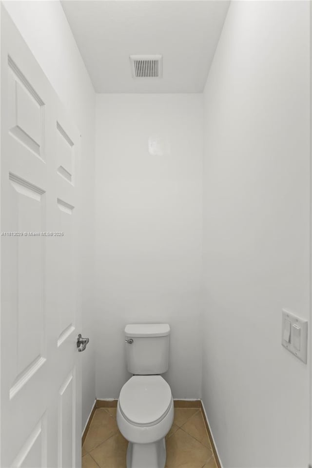 3502 W 86th Ter, Hialeah, FL 33018 - bathroom featuring tile patterned flooring, toilet, and baseboards