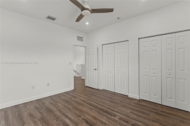 3502 W 86th Ter, Hialeah, FL 33018 - unfurnished bedroom featuring multiple closets, dark wood-style flooring, baseboards, recessed lighting, and ceiling fan