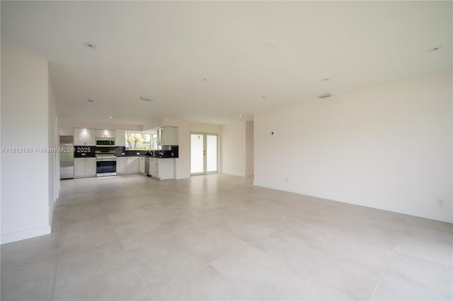 6640 SW 7th St, Pembroke Pines, FL 33023 - unfurnished living room featuring baseboards
