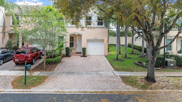 16316 SW 48th St, Miramar, FL 33027 - view of property with stucco siding, decorative driveway, and a garage