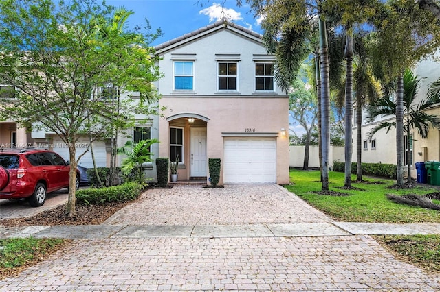 16316 SW 48th St, Miramar, FL 33027 - view of front facade featuring stucco siding, decorative driveway, and an attached garage