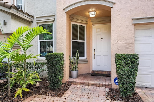 16316 SW 48th St, Miramar, FL 33027 - view of exterior entry featuring stucco siding and a garage