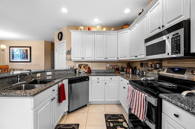 16316 SW 48th St, Miramar, FL 33027 - kitchen with appliances with stainless steel finishes, a sink, a peninsula, white cabinetry, and light tile patterned floors