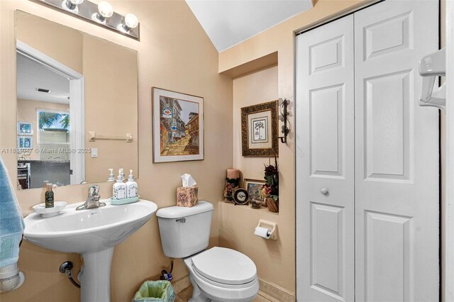 16316 SW 48th St, Miramar, FL 33027 - bathroom with a closet, toilet, lofted ceiling, and baseboards