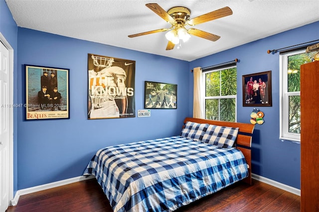 16316 SW 48th St, Miramar, FL 33027 - bedroom featuring hardwood / wood-style floors, baseboards, a ceiling fan, and a textured ceiling