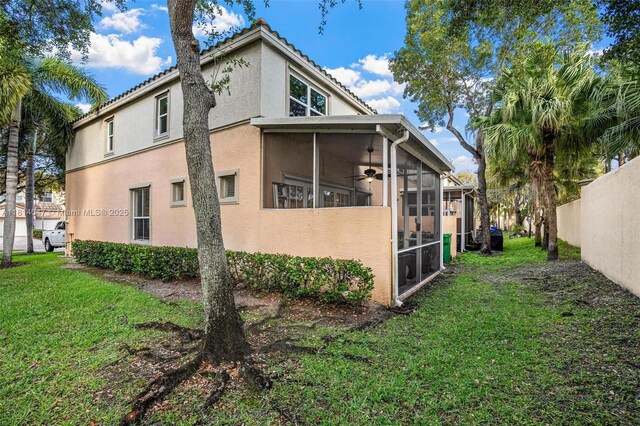 16316 SW 48th St, Miramar, FL 33027 - view of property exterior featuring a sunroom, stucco siding, and a tile roof