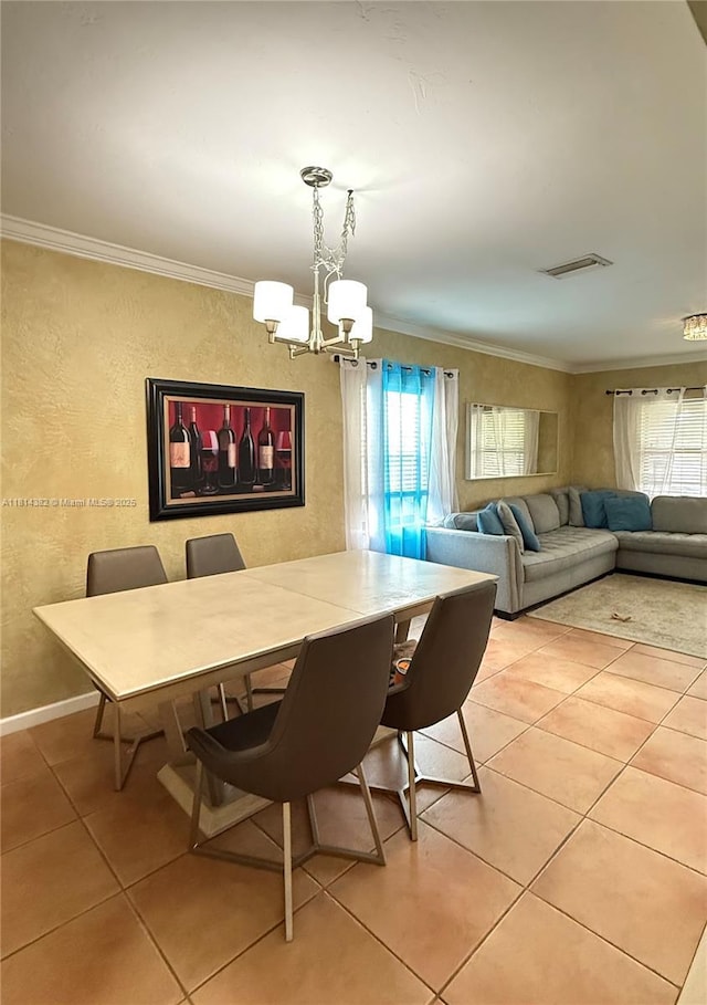 7420 SW 34th Ter, Miami, FL 33155 - dining room with plenty of natural light, a chandelier, light tile patterned flooring, crown molding, and a textured wall
