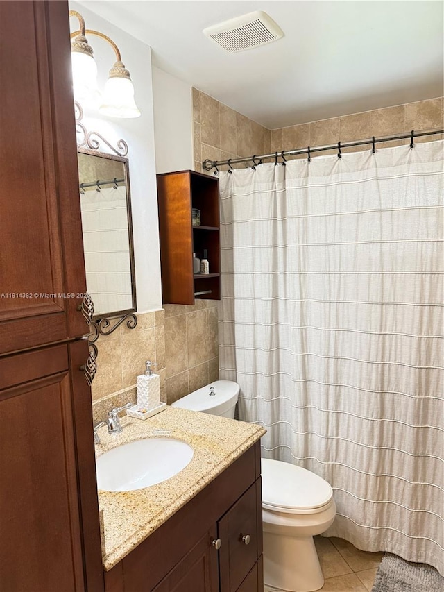 7420 SW 34th Ter, Miami, FL 33155 - bathroom featuring tile walls, toilet, vanity, tile patterned floors, and backsplash