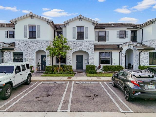 18058 SW 147th Ct, Miami, FL 33187 - townhome / multi-family property with stucco siding, stone siding, and uncovered parking