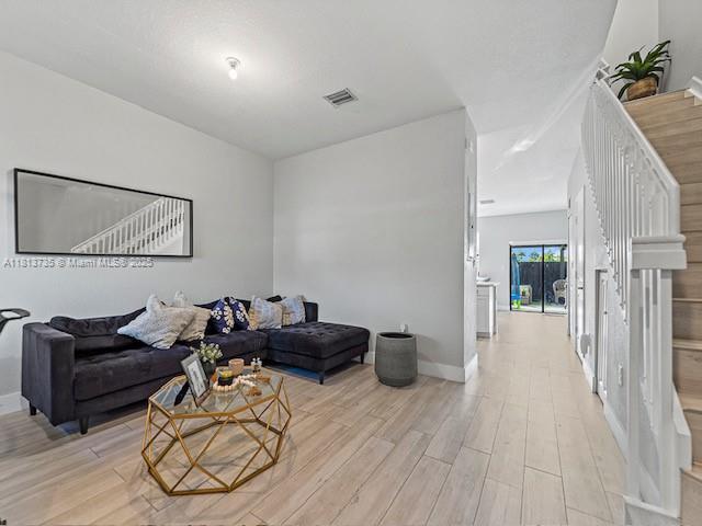 18058 SW 147th Ct, Miami, FL 33187 - living room featuring light wood-style floors and baseboards