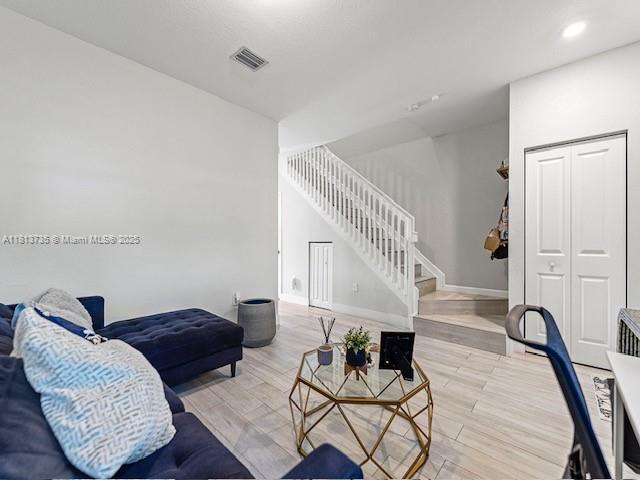 18058 SW 147th Ct, Miami, FL 33187 - living area featuring stairs, wood finished floors, and recessed lighting