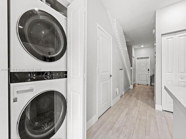 18058 SW 147th Ct, Miami, FL 33187 - washroom featuring estacked washer and dryer, light wood-type flooring, and recessed lighting