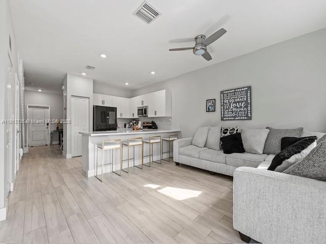 18058 SW 147th Ct, Miami, FL 33187 - living room with a ceiling fan, light wood-style flooring, and recessed lighting