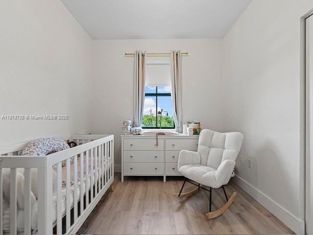18058 SW 147th Ct, Miami, FL 33187 - bedroom with light wood finished floors and a nursery area