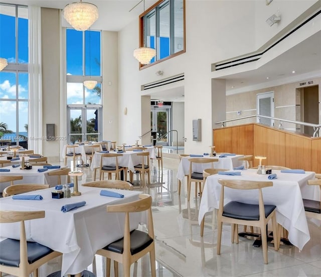 18683 Collins Ave Unit 2510, Sunny Isles Beach, FL 33160 - dining room with a high ceiling and light tile patterned flooring