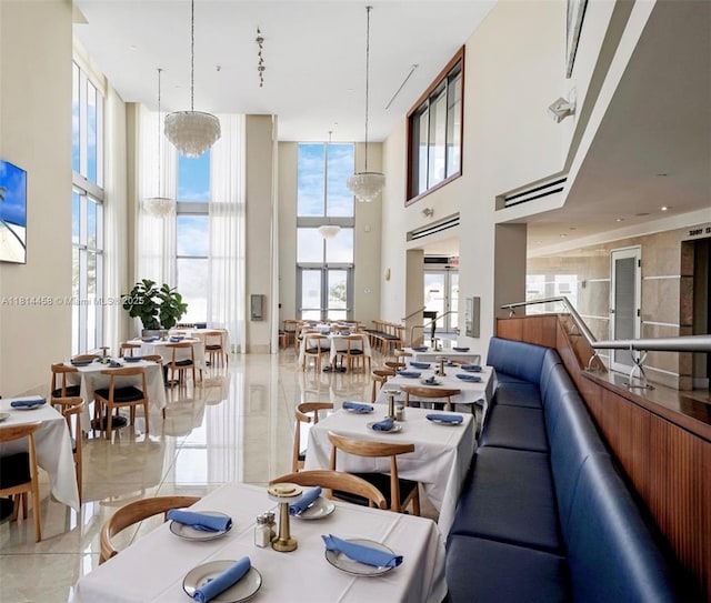 18683 Collins Ave Unit 2510, Sunny Isles Beach, FL 33160 - dining space with a high ceiling, light tile patterned floors, and floor to ceiling windows