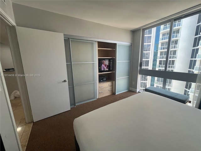 18683 Collins Ave Unit 2510, Sunny Isles Beach, FL 33160 - bedroom with a closet, carpet floors, and a wall of windows
