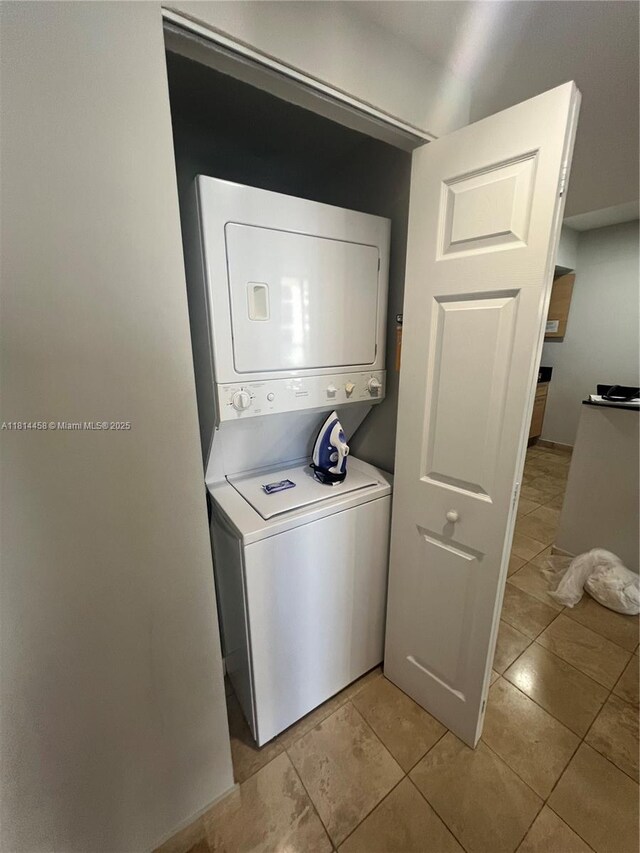 18683 Collins Ave Unit 2510, Sunny Isles Beach, FL 33160 - washroom featuring stacked washer and clothes dryer and light tile patterned flooring