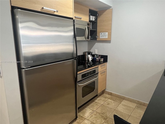 18683 Collins Ave Unit 2510, Sunny Isles Beach, FL 33160 - kitchen featuring stainless steel appliances, light tile patterned floors, dark countertops, and open shelves