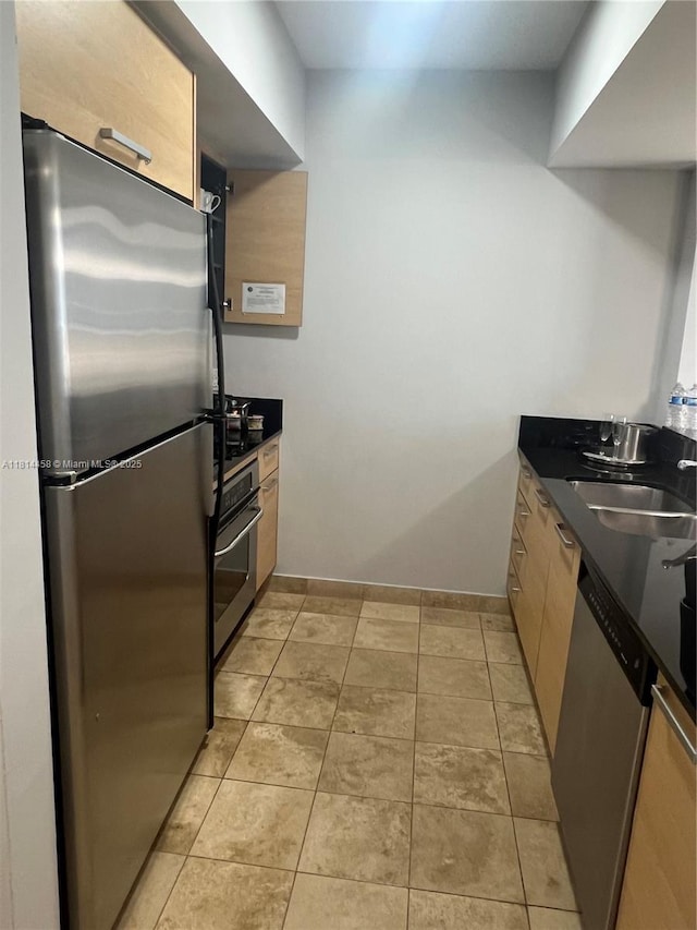 18683 Collins Ave Unit 2510, Sunny Isles Beach, FL 33160 - kitchen with appliances with stainless steel finishes, dark countertops, and light tile patterned floors