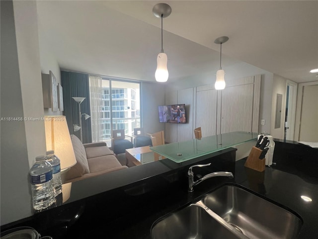 18683 Collins Ave Unit 2510, Sunny Isles Beach, FL 33160 - kitchen featuring hanging light fixtures and dark countertops