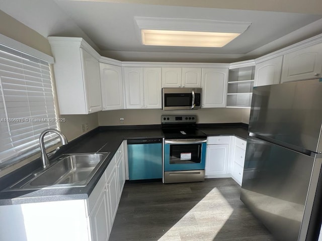617 Ixoria Ave Unit 18, Fort Pierce, FL 34982 - kitchen with appliances with stainless steel finishes, a sink, dark wood-type flooring, white cabinets, and open shelves