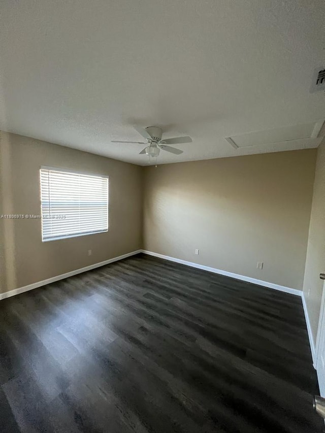 617 Ixoria Ave Unit 18, Fort Pierce, FL 34982 - empty room with dark wood finished floors, baseboards, and a ceiling fan