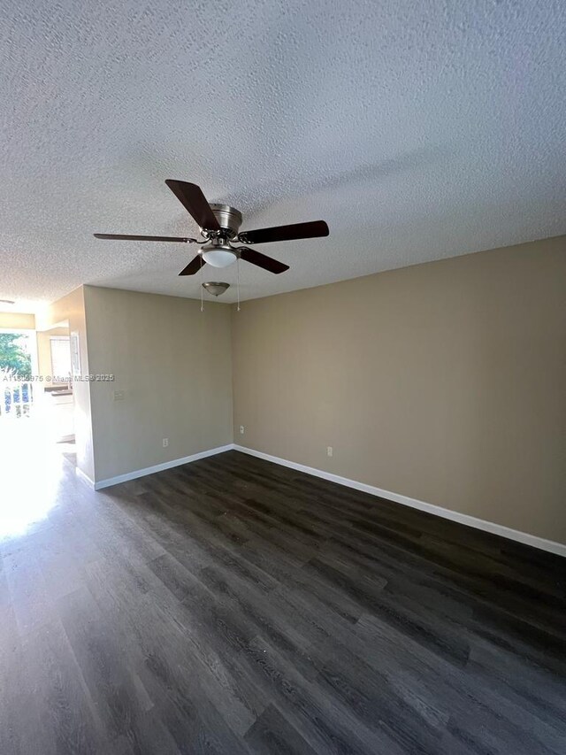617 Ixoria Ave Unit 18, Fort Pierce, FL 34982 - empty room featuring dark wood-style floors, a ceiling fan, baseboards, and a textured ceiling