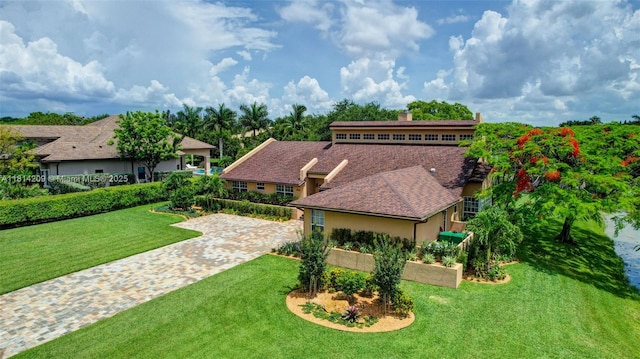 13241 SW 32nd Ct, Davie, FL 33330 - view of front of home featuring a chimney, a front yard, and stucco siding
