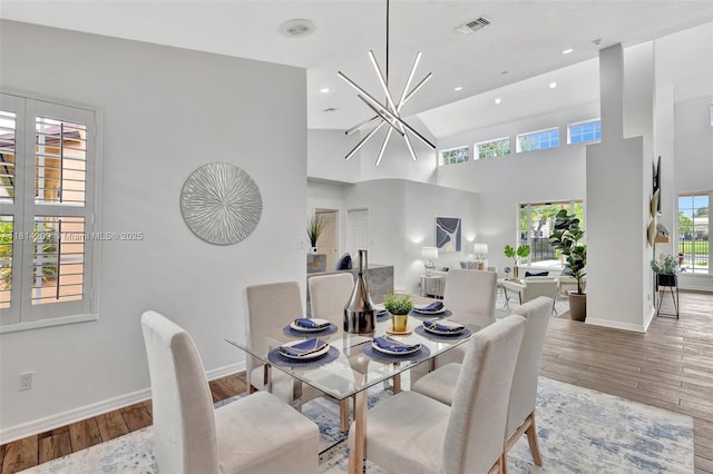 13241 SW 32nd Ct, Davie, FL 33330 - dining room with baseboards, hardwood / wood-style flooring, recessed lighting, a towering ceiling, and a chandelier