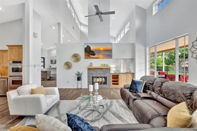 13241 SW 32nd Ct, Davie, FL 33330 - living room with high vaulted ceiling, wood finished floors, a ceiling fan, a glass covered fireplace, and baseboards