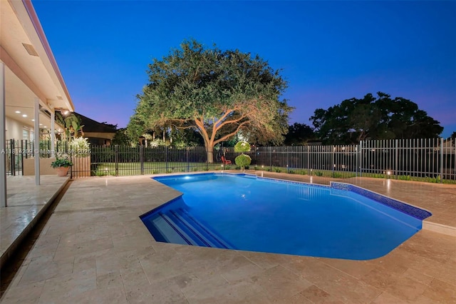 13241 SW 32nd Ct, Davie, FL 33330 - pool at dusk featuring a patio and a fenced backyard