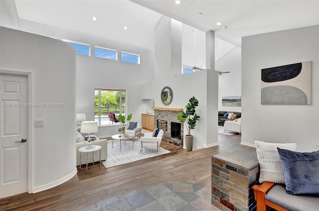 13241 SW 32nd Ct, Davie, FL 33330 - living room featuring hardwood / wood-style flooring, ceiling fan, a glass covered fireplace, a towering ceiling, and recessed lighting