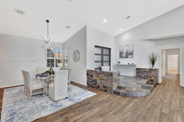 13241 SW 32nd Ct, Davie, FL 33330 - dining space featuring wood finished floors, high vaulted ceiling, and a chandelier