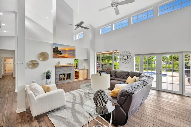 13241 SW 32nd Ct, Davie, FL 33330 - living area featuring high vaulted ceiling, ceiling fan, french doors, wood finished floors, and a glass covered fireplace