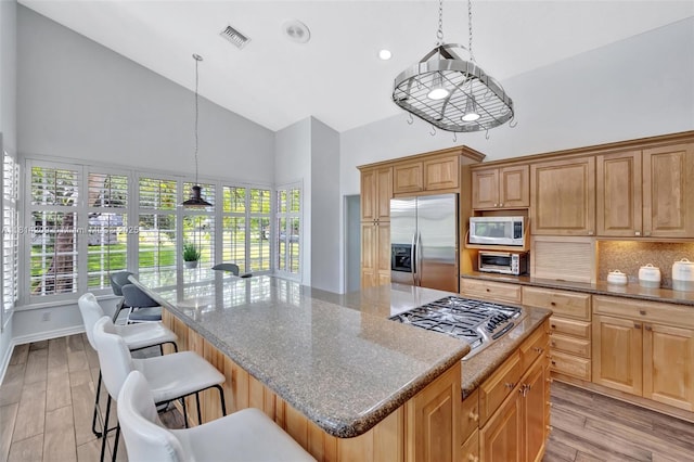 13241 SW 32nd Ct, Davie, FL 33330 - kitchen with appliances with stainless steel finishes, high vaulted ceiling, backsplash, a center island, and healthy amount of natural light