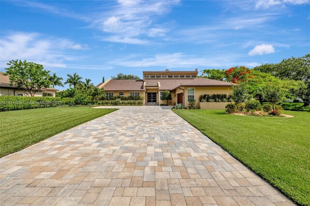 13241 SW 32nd Ct, Davie, FL 33330 - view of front of house with decorative driveway, a front yard, and stucco siding