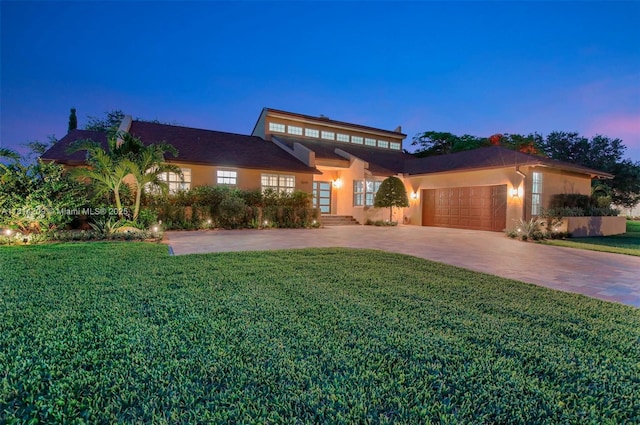 13241 SW 32nd Ct, Davie, FL 33330 - view of front of property with a garage, a lawn, driveway, and stucco siding