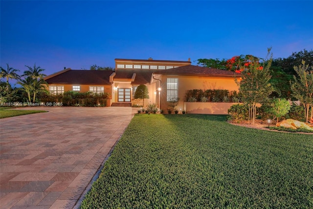 13241 SW 32nd Ct, Davie, FL 33330 - view of front of property with decorative driveway, french doors, a front lawn, and stucco siding