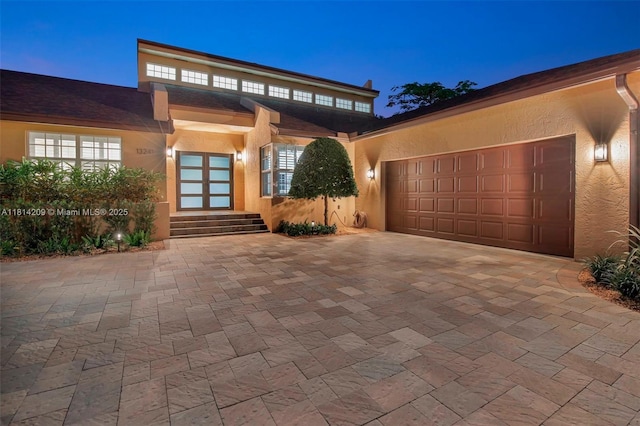 13241 SW 32nd Ct, Davie, FL 33330 - view of front of home featuring stucco siding, a garage, decorative driveway, and entry steps