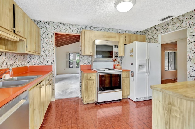 1360 NW 94th Ave, Plantation, FL 33322 - kitchen featuring stainless steel appliances, wallpapered walls, a sink, a textured ceiling, and light countertops