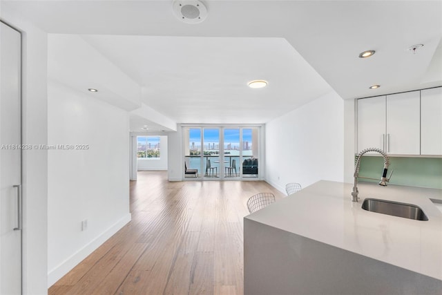 1900 Sunset Harbour Dr Unit 1814, Miami Beach, FL 33139 - kitchen featuring white cabinetry, light wood finished floors, open floor plan, modern cabinets, and recessed lighting