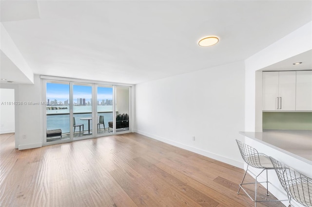 1900 Sunset Harbour Dr Unit 1814, Miami Beach, FL 33139 - unfurnished living room featuring light wood-type flooring and a wall of windows